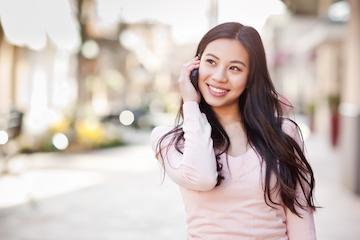 woman on the phone with cosmetic dentist in Vancouver