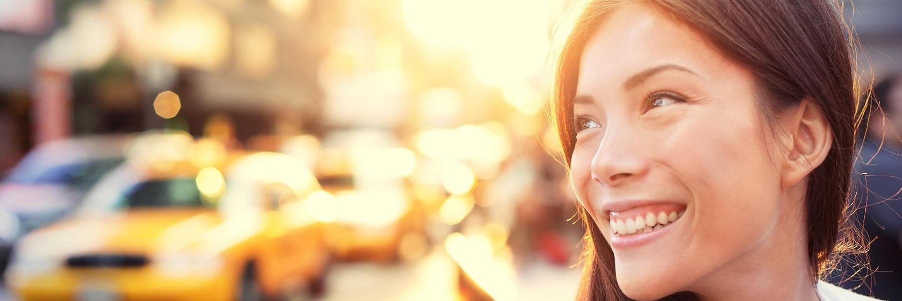 A woman smiling in the city | tooth reshaping in Vancouver BC