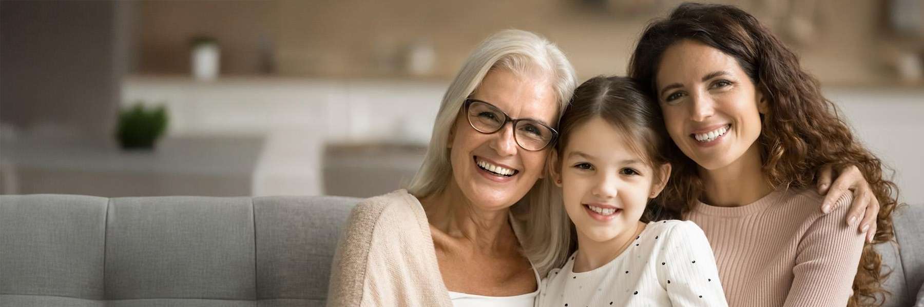 mother, daughter, and granddaughter smiling