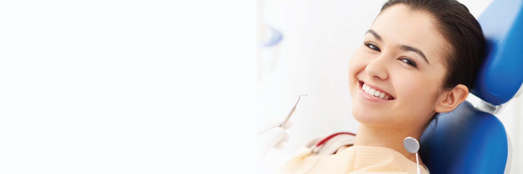 Smiling woman relaxing in dental chair during a dental implant procedure visit