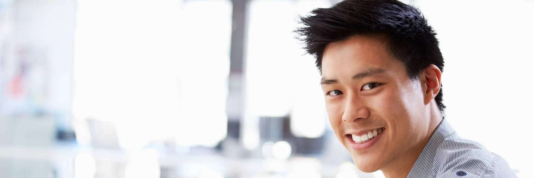 A smiling man in the office | East Vancouver dentist