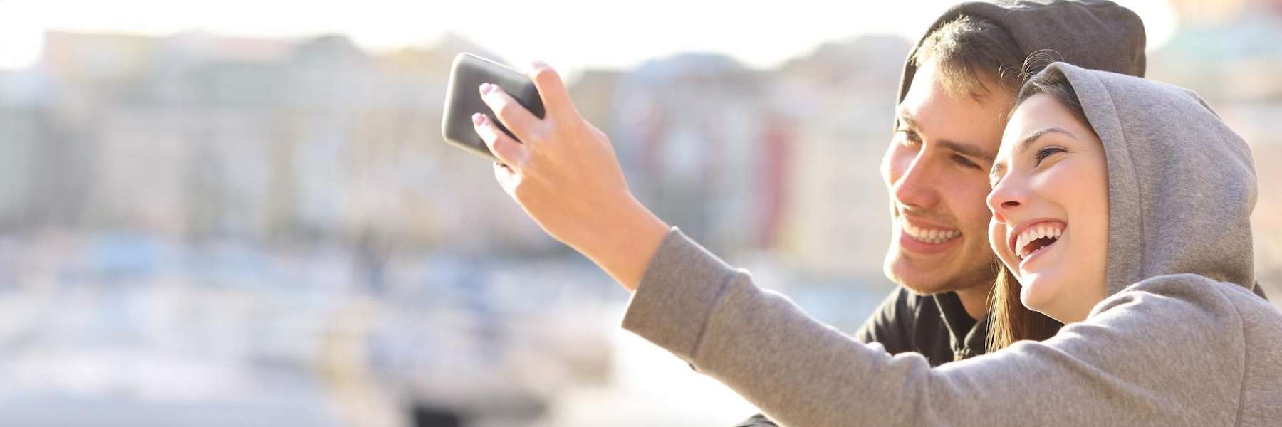 A couple taking a selfie outside