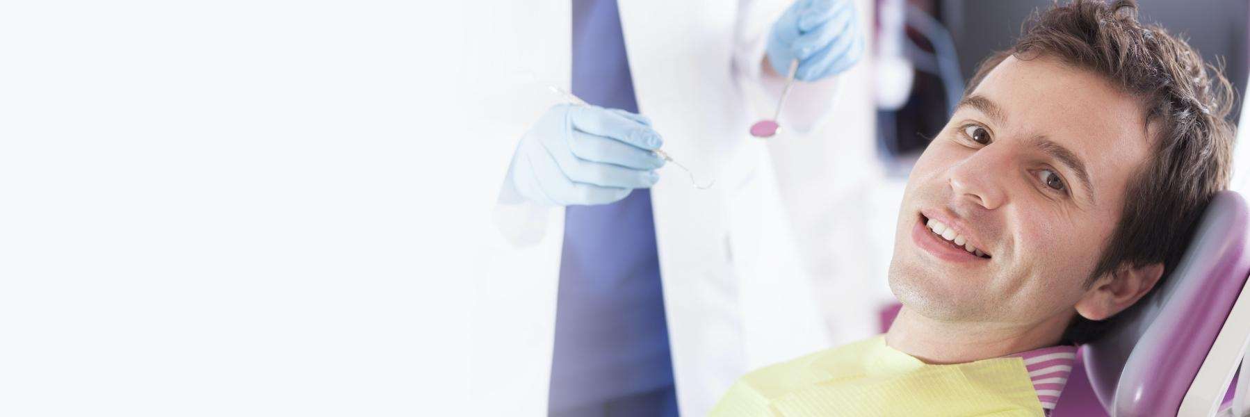 A smiling man getting a dental exam