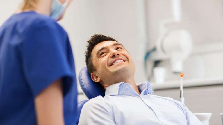 A man receiving a dental crown consultation