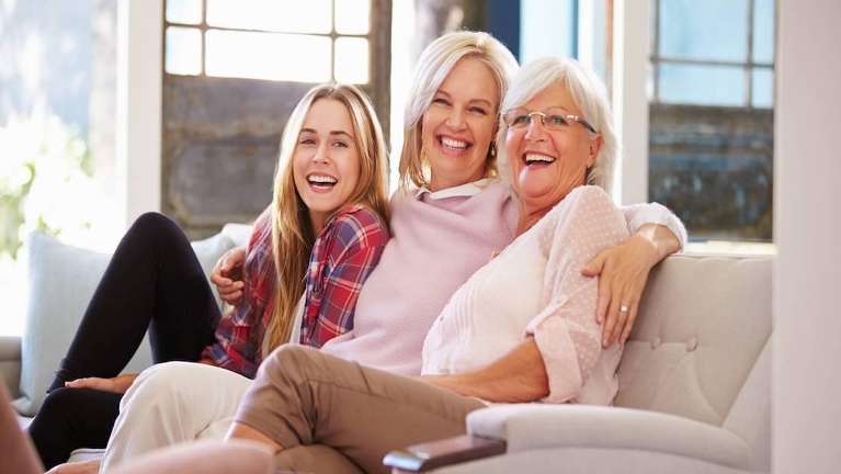 A family laughing on the couch | dentist Vancouver