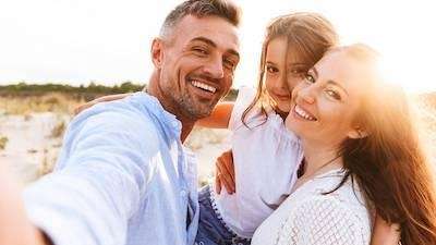A family smiling at the beach | best Vancouver dentist