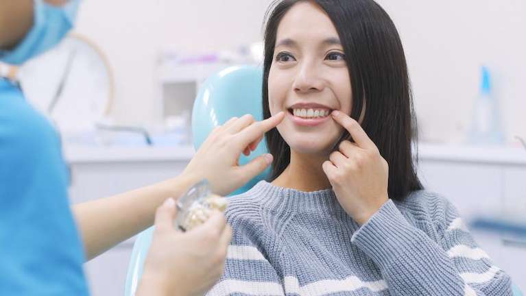 A woman getting a dental mold at the dentist