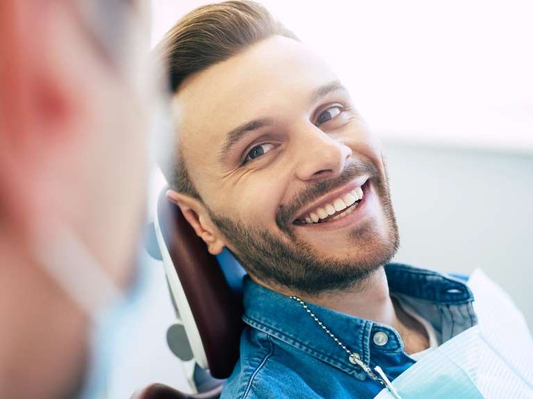 A smiling man at the dentist's office