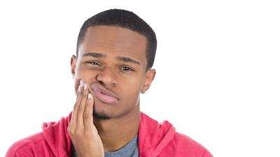 A man experiencing tooth pain | Root canal Vancouver