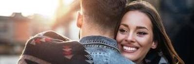 Two people hugging | dental implants Vancouver