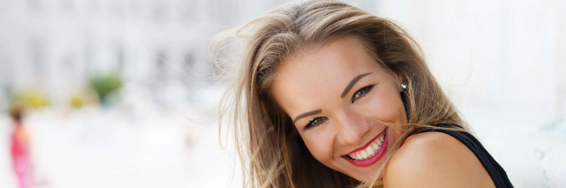 A smiling woman with Vancouver Botox outside