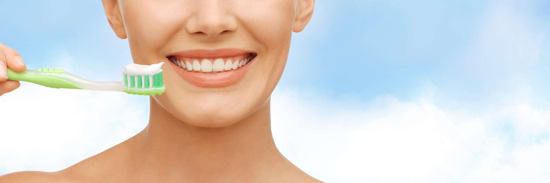 A woman holding a toothbrush and toothpaste